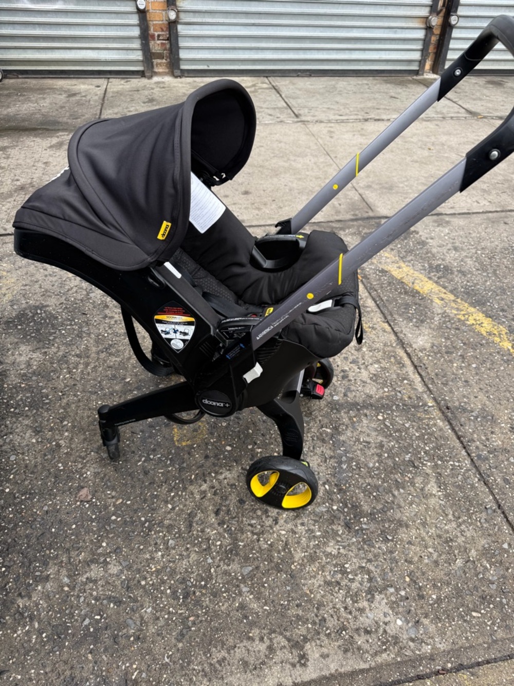 Doona Black Infant Car Seat Carrier / stroller with Yellow Accents